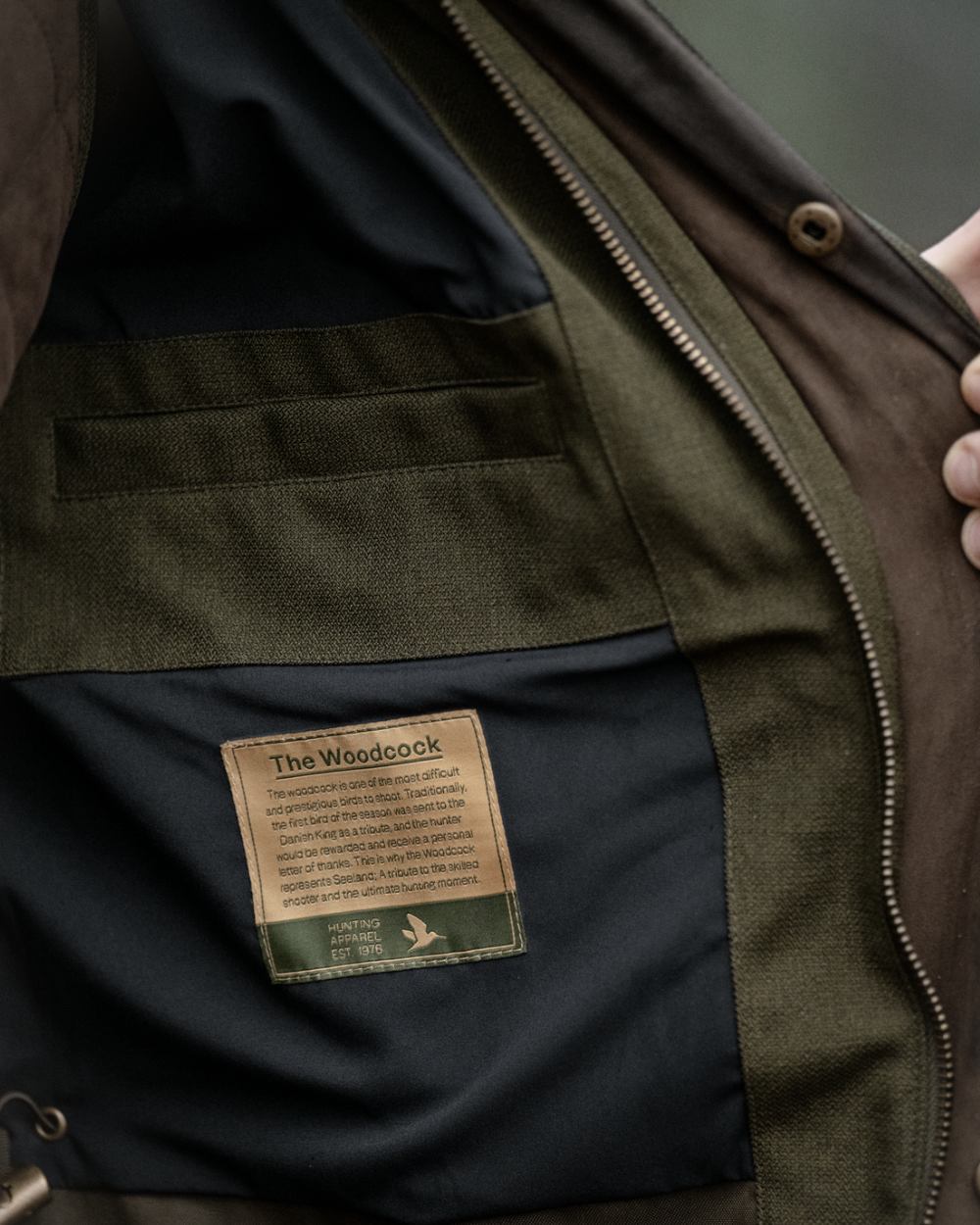 Shaded Olive coloured Seeland Mens Woodcock Royale Jacket on forest background 