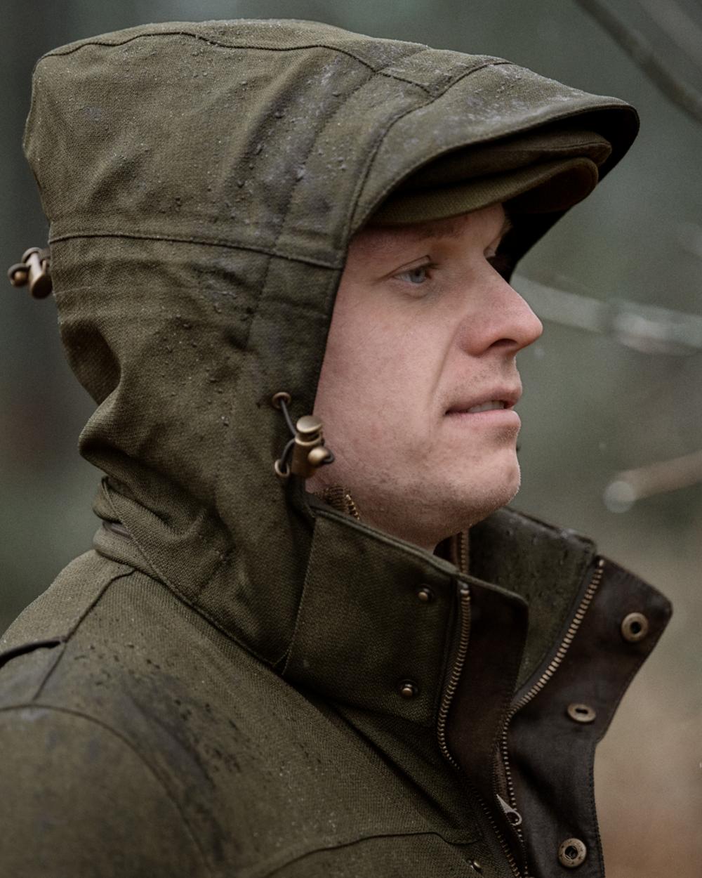 Shaded Olive coloured Seeland Mens Woodcock Royale Jacket on forest background 