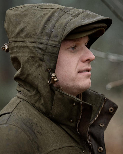 Shaded Olive coloured Seeland Mens Woodcock Royale Jacket on forest background 