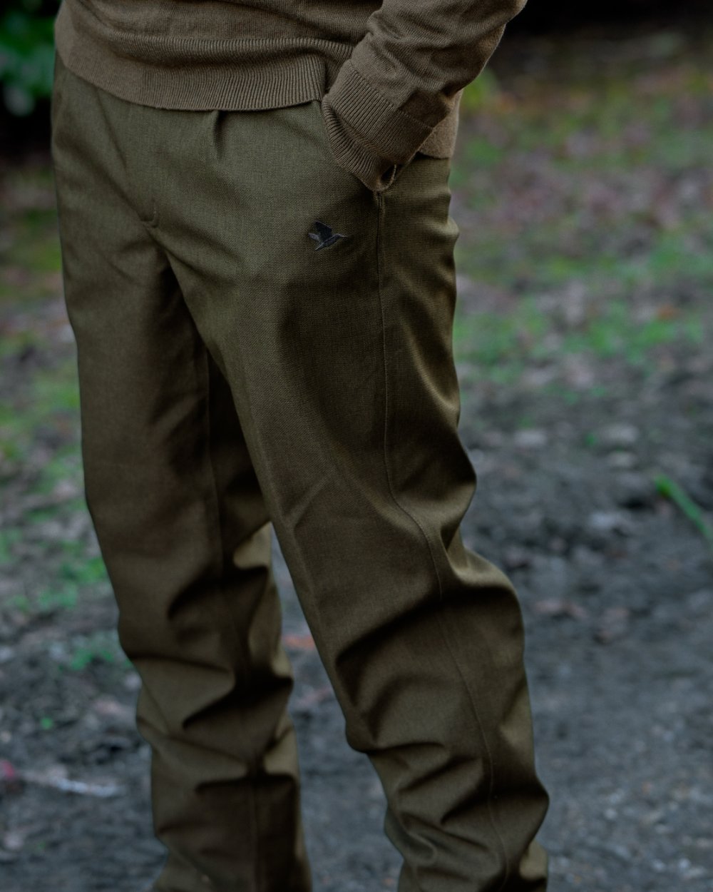 Shaded Olive coloured Seeland Mens Woodcock Royale Trousers on forest background 