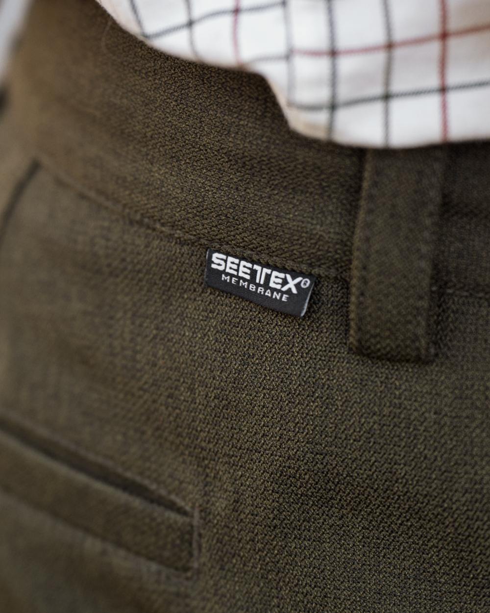 Shaded Olive coloured Seeland Mens Woodcock Royale Trousers on forest background 