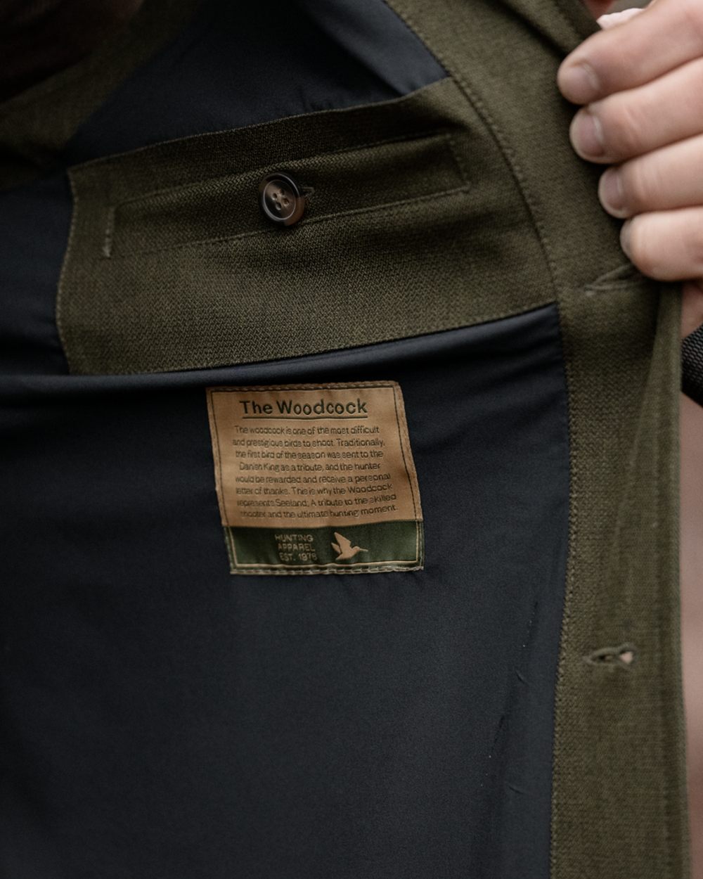 Shaded Olive coloured Seeland Mens Woodcock Royale Waistcoat on forest background 