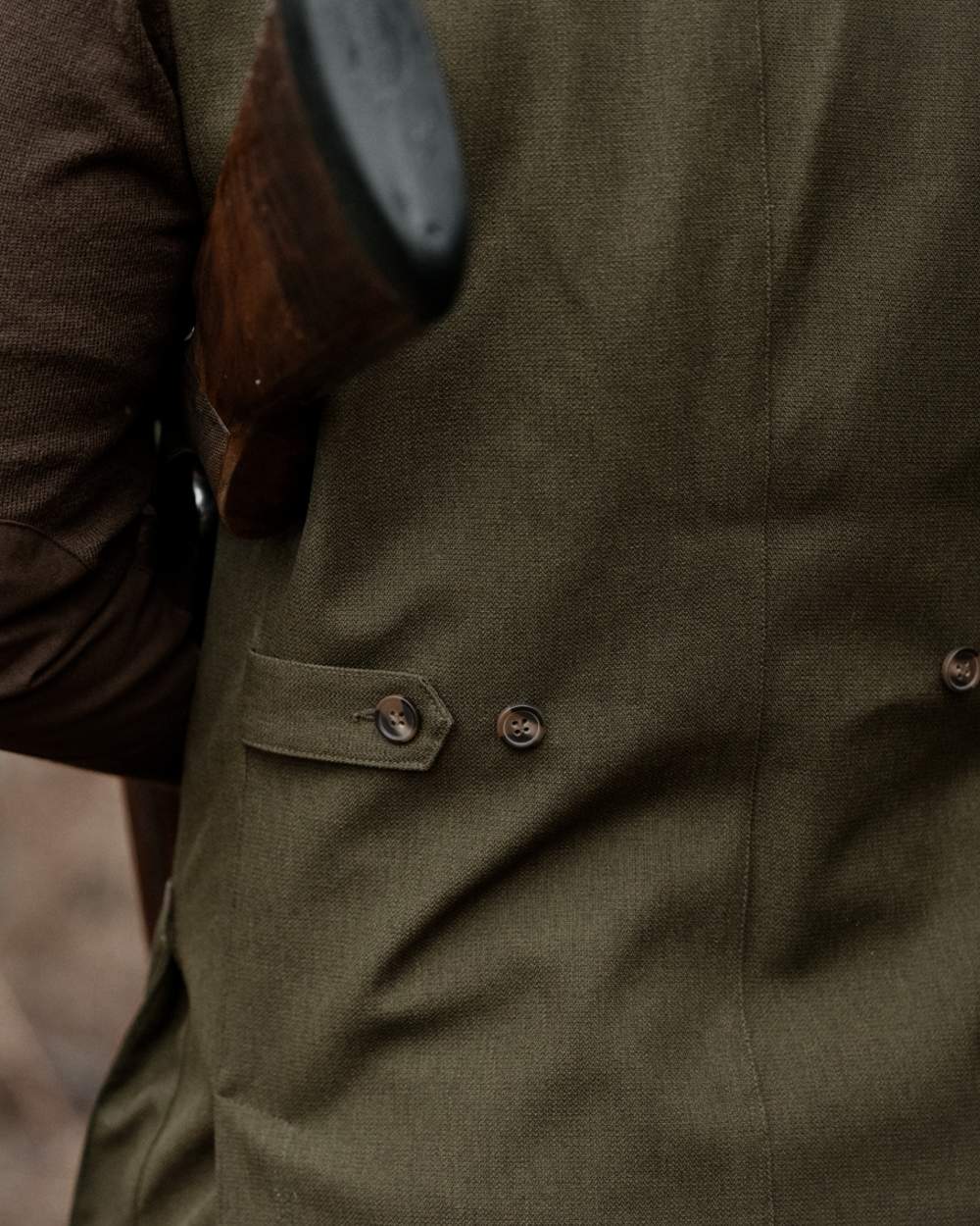 Shaded Olive coloured Seeland Mens Woodcock Royale Waistcoat on forest background 