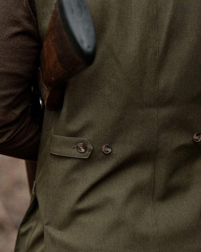 Shaded Olive coloured Seeland Mens Woodcock Royale Waistcoat on forest background 