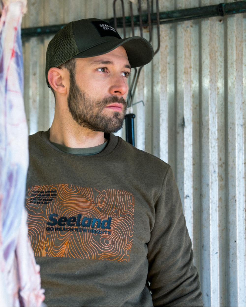 Dark Olive Melange Coloured Seeland Pulse Sweatshirt on farm background 