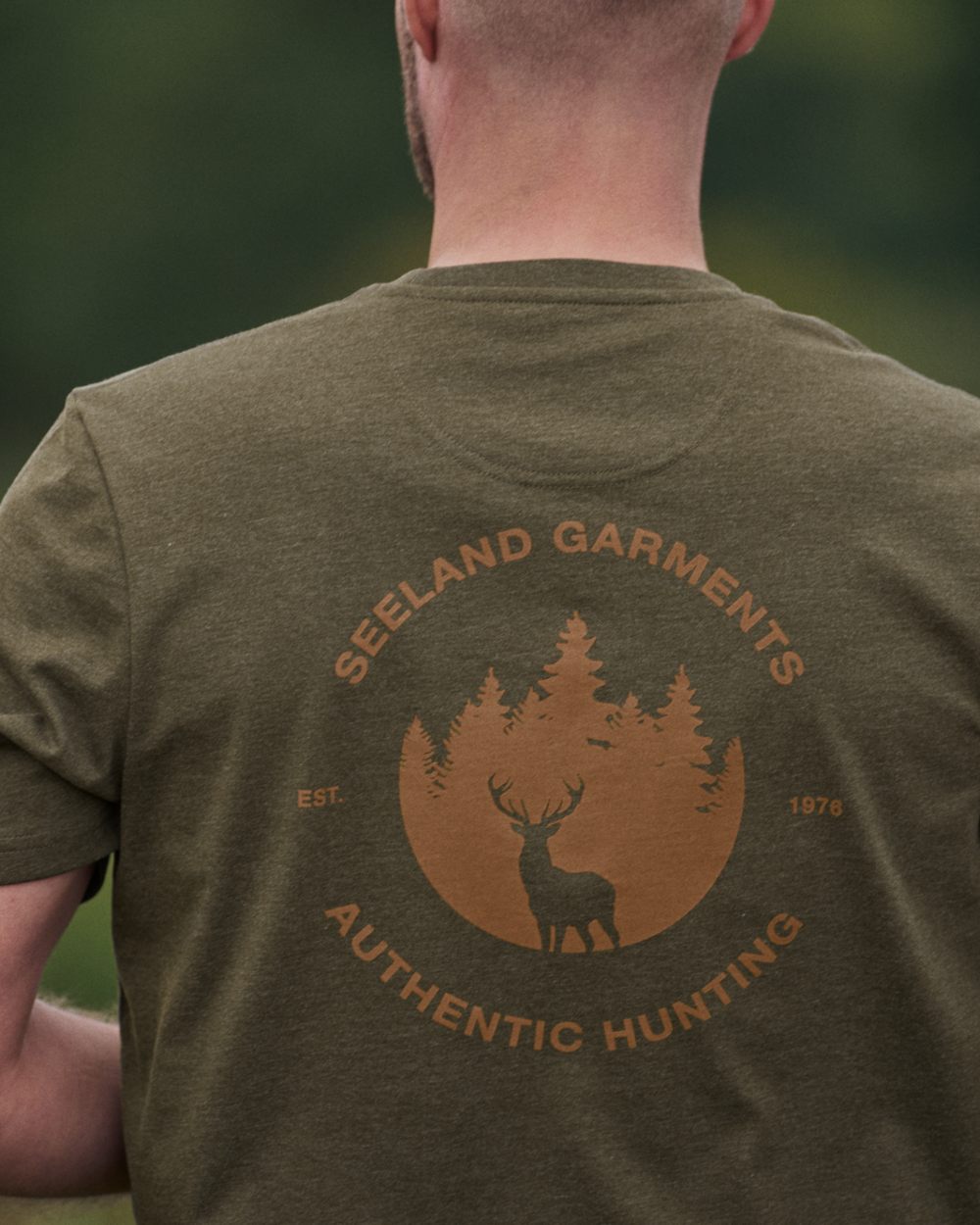 Pine Green Melange coloured Seeland Saker T-Shirt on camp background 