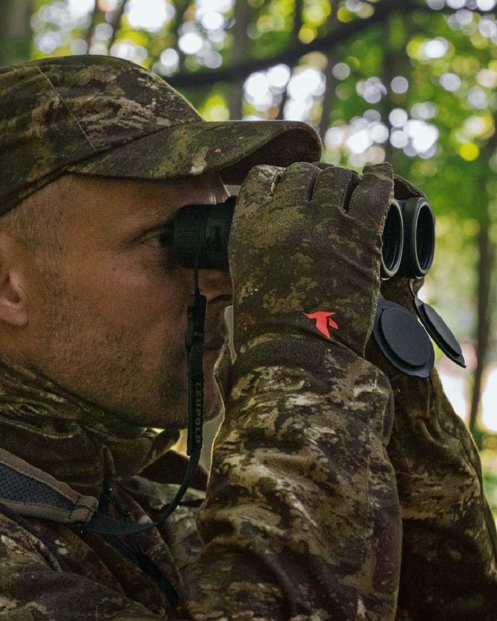 InVis Green Coloured Seeland Scent Control Camo Balaclava on forest background 