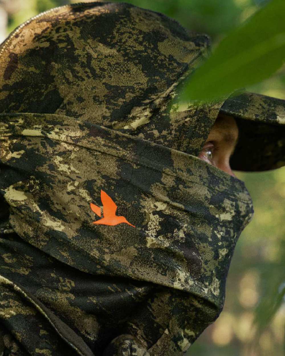 InVis Green Coloured Seeland Scent Control Camo Balaclava on forest background 