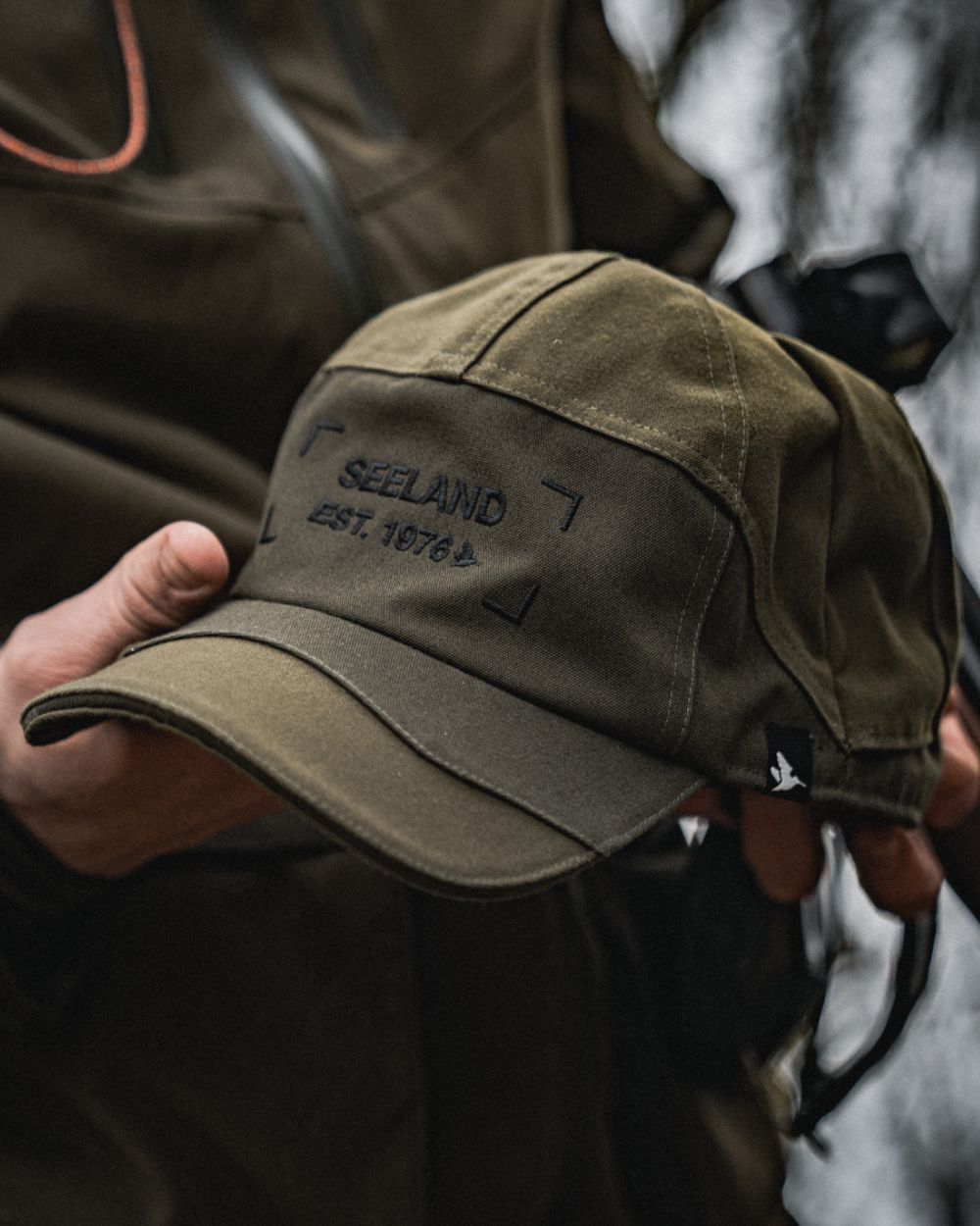 Light Pine Coloured Seeland Trax Cap on forest background 