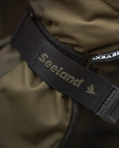 Pine Green coloured Seeland Trigger Fold-Back Gloves on forest background 