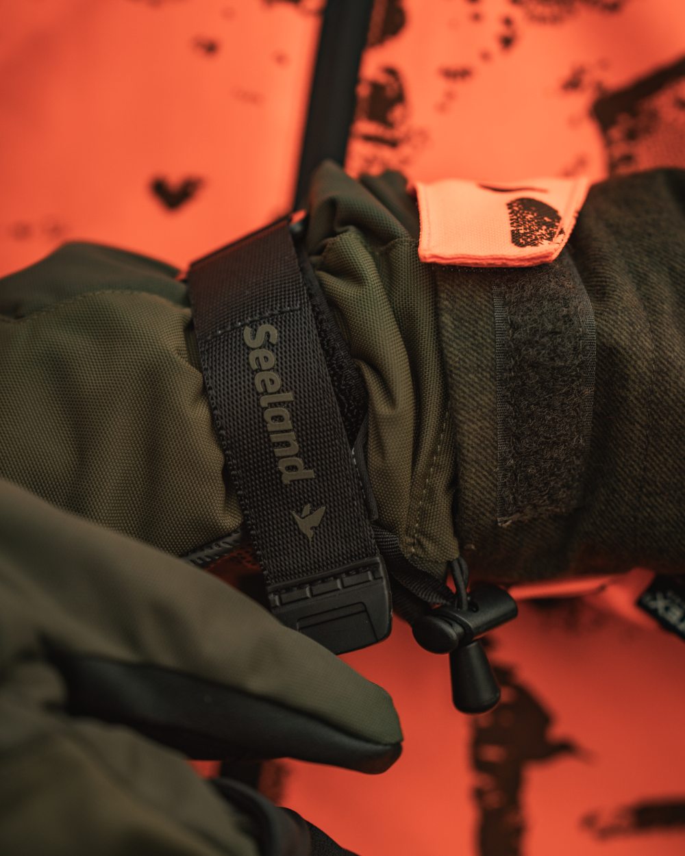 Pine Green coloured Seeland Trigger Fold-Back Gloves on forest background 