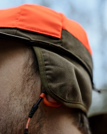 Grizzly Brown coloured Seeland Ultimo Cap on forest background 