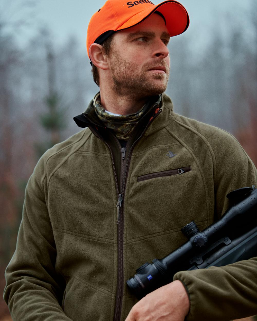 Pine Green InVis Orange Blaze Coloured Seeland Vantage Reversible Fleece Jacket on forest background 