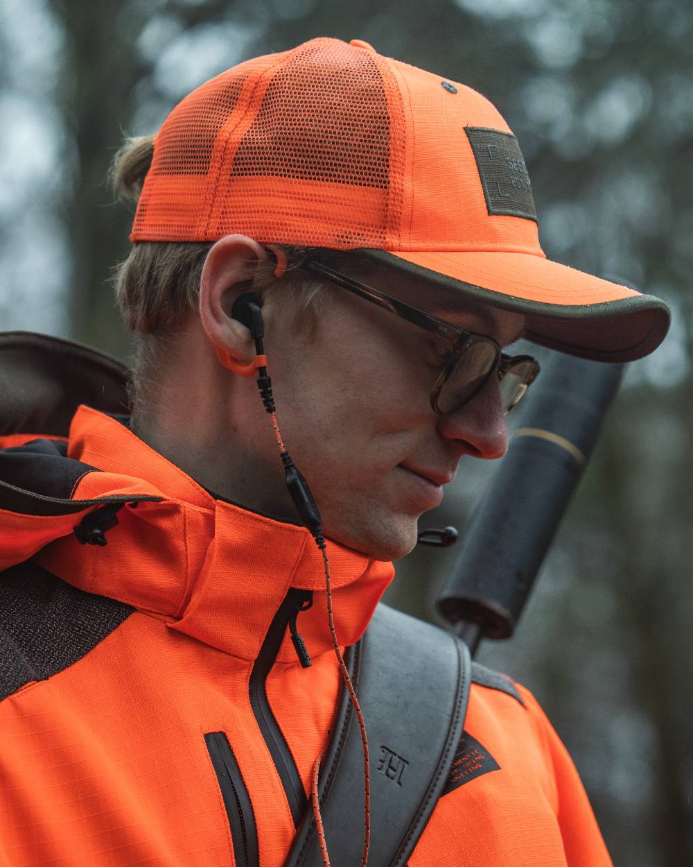 Orange Blaze coloured Seeland Venture Rover Cap on forest background 