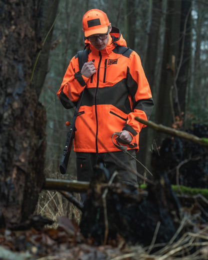 Orange Blaze coloured Seeland Venture Rover Cap on forest background 