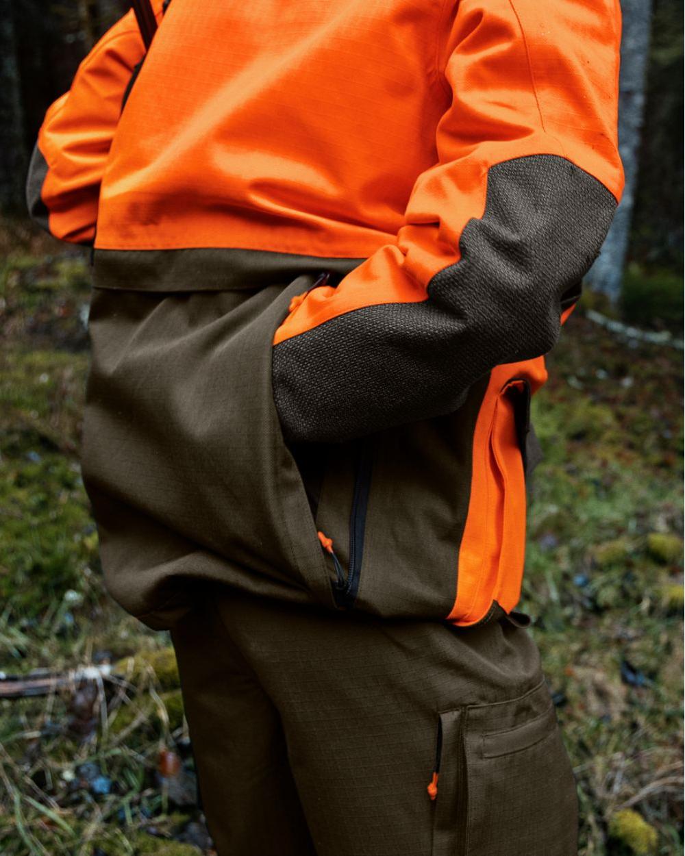 Pine Green Hi-Vis Orange Coloured Seeland Venture Rover Jacket on forest background 