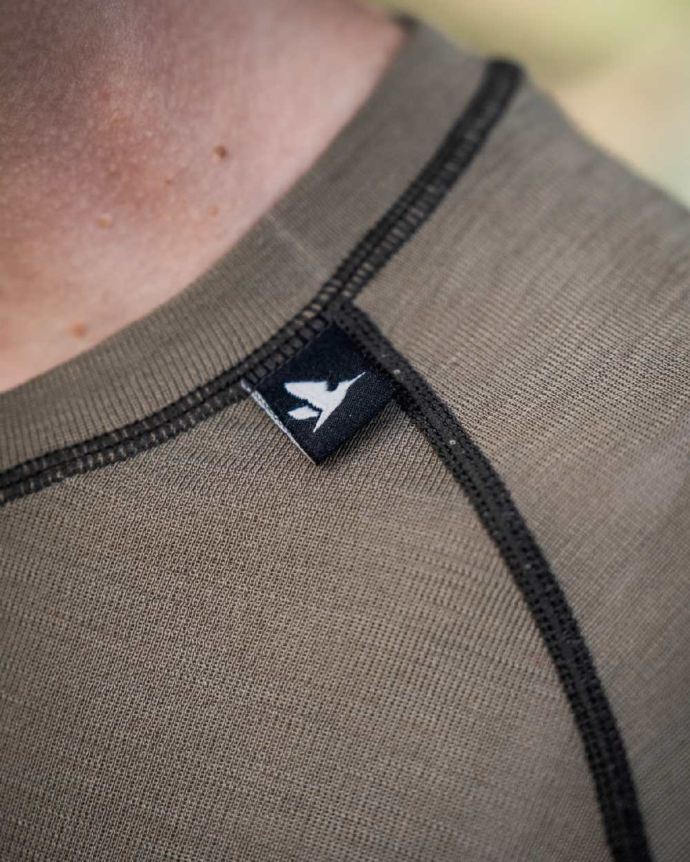 Covert Green Coloured Seeland Womens Apex Aia Merino T-shirt on outdoor background
