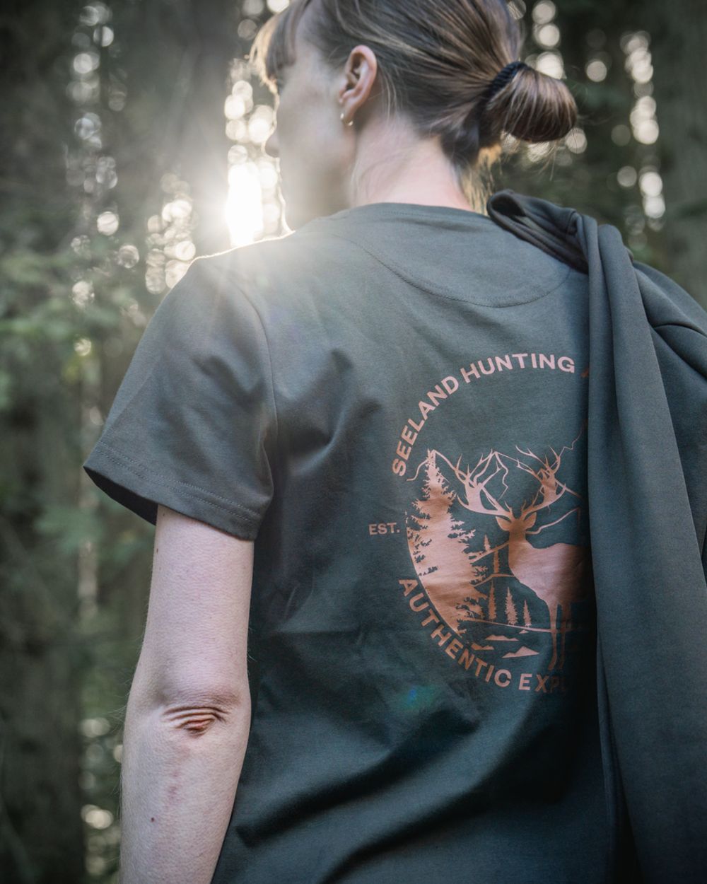 Pine Green Coloured Seeland Womens Hunting Heritage T-Shirt on forest background 
