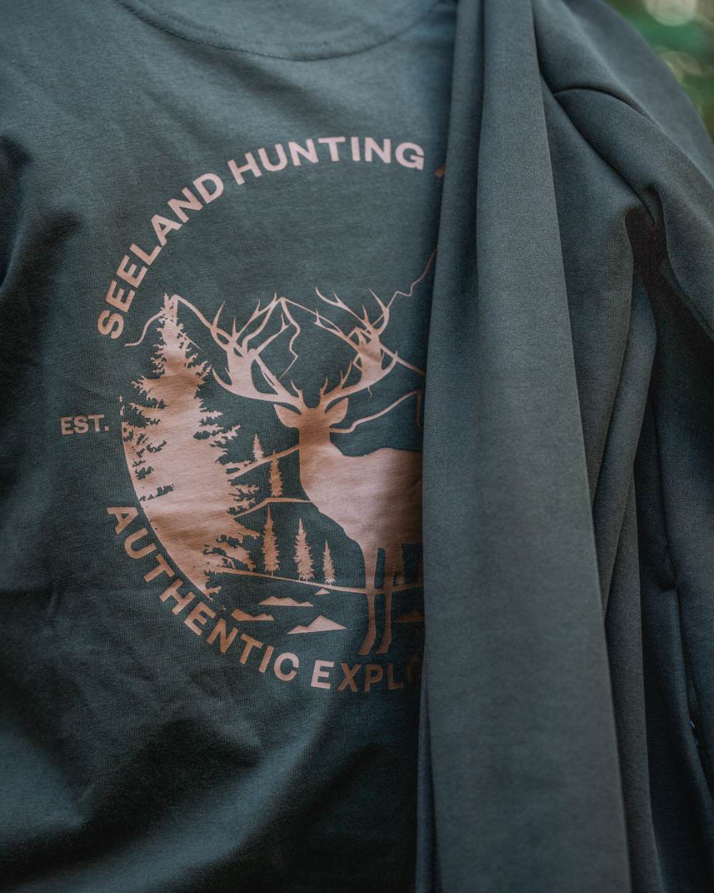 Pine Green Coloured Seeland Womens Hunting Heritage T-Shirt on forest background 