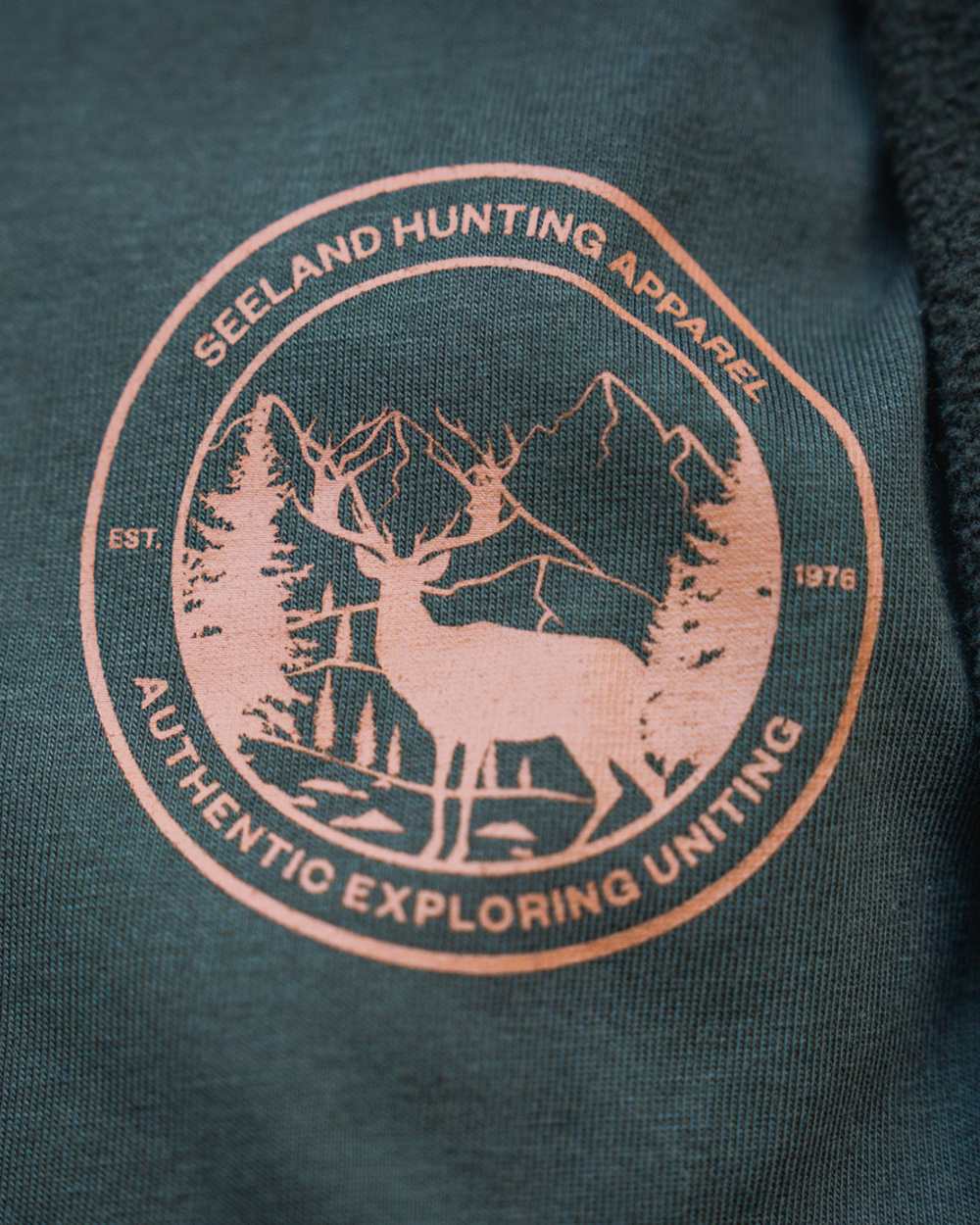 Pine Green Coloured Seeland Womens Hunting Heritage T-Shirt on forest background 