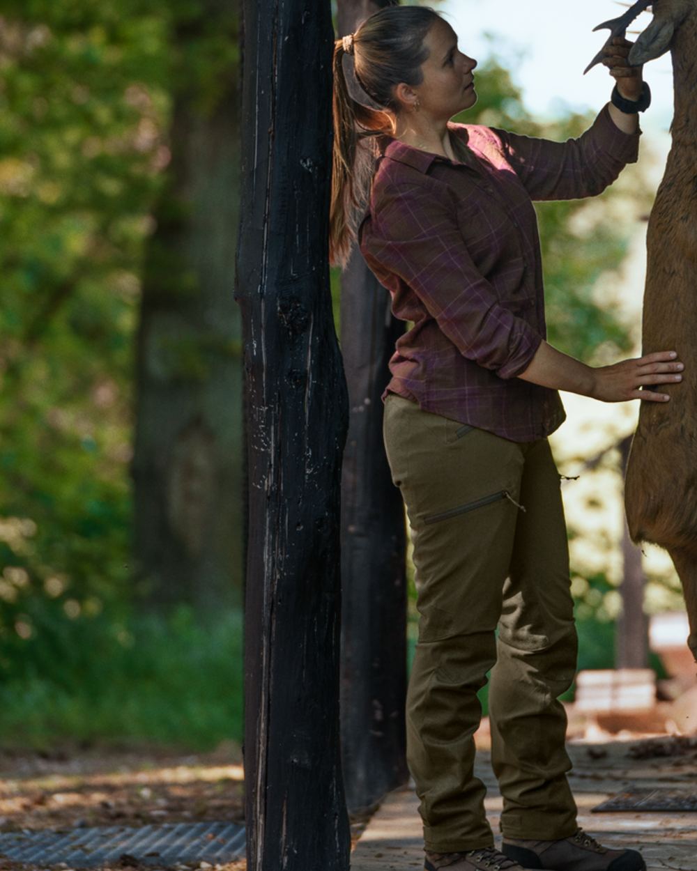 Pine Green coloured Seeland Womens Larch Membrane Trousers on forest background 
