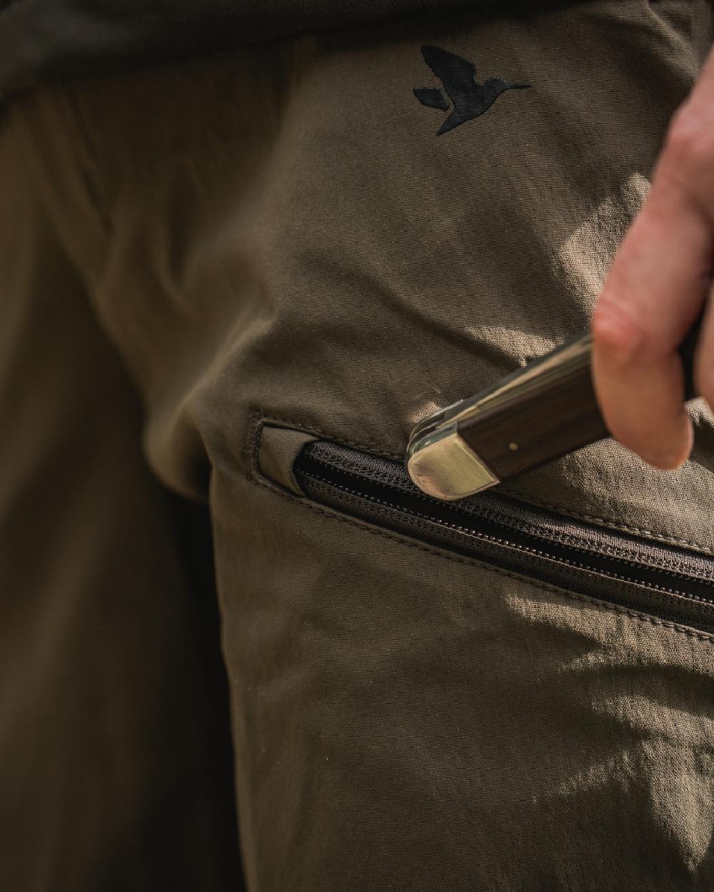 Pine Green Chocolate Torte coloured Seeland Womens Larch Stretch Trousers on forest background 