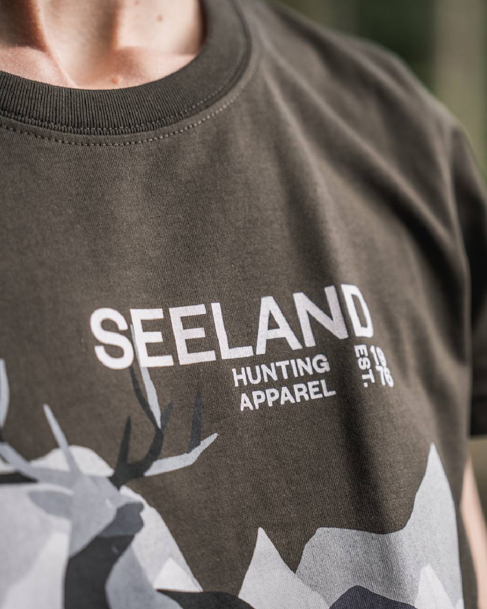 Pine Green Coloured Seeland Womens Sadie T-Shirt on blurry background 
