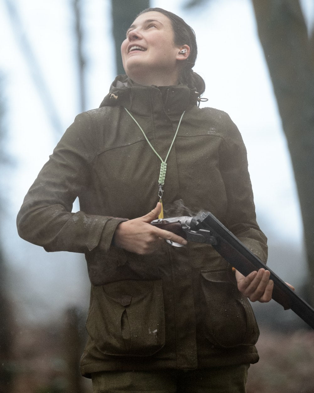 Shaded Olive coloured Seeland Womens Woodcock Royale Eve Jacket on forest background 