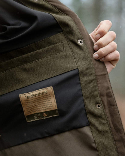 Shaded Olive coloured Seeland Womens Woodcock Royale Eve Jacket on forest background 