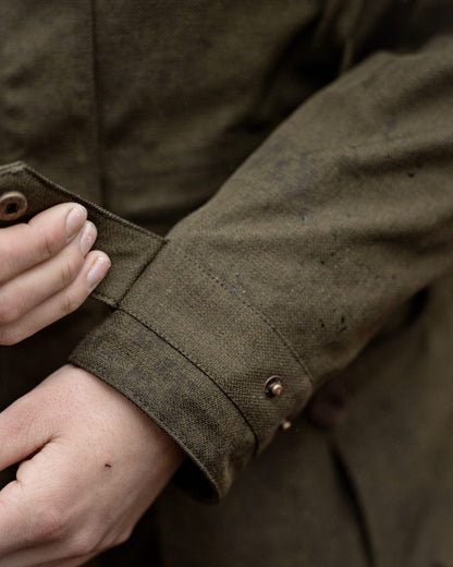 Shaded Olive coloured Seeland Womens Woodcock Royale Eve Jacket on forest background 