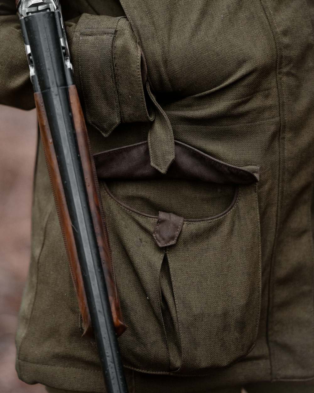 Shaded Olive coloured Seeland Womens Woodcock Royale Eve Jacket on forest background 