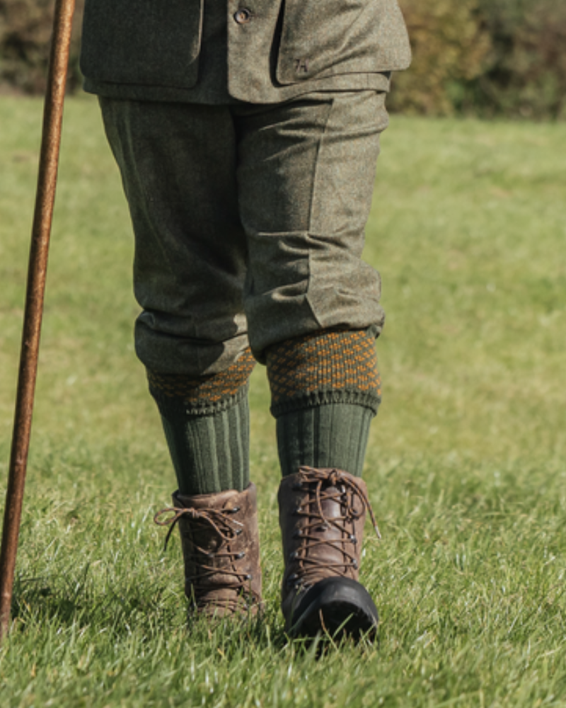 Person wearing Härkila shooting breeks with long shooting socks and walking boots outdoors