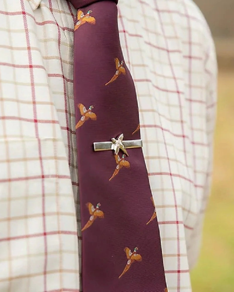 Close-up of a Jack Pyke pheasant print tie worn with a country check shirt
