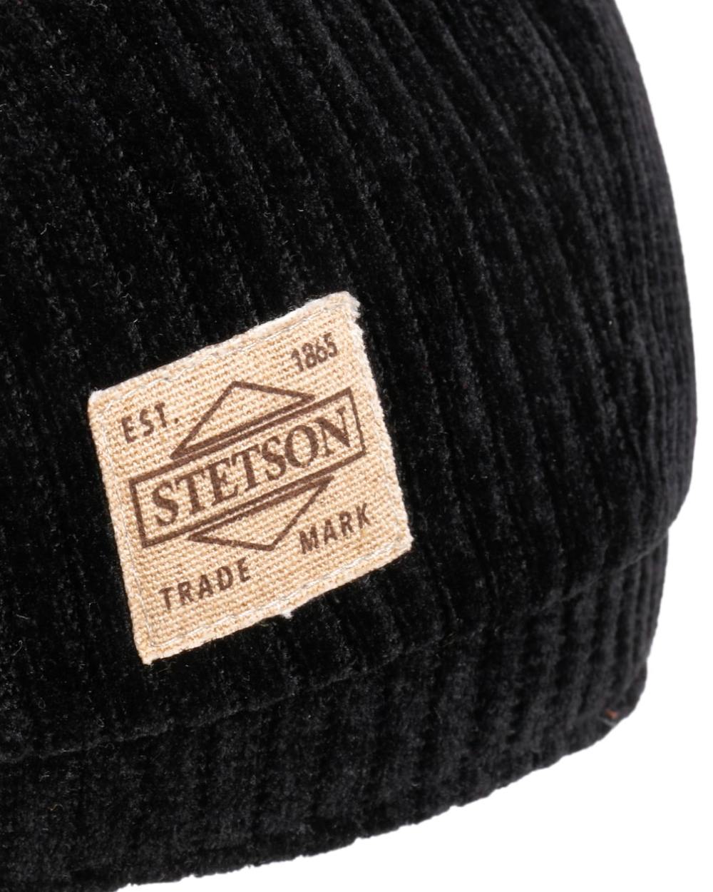 Black coloured Stetson Hatteras Corduroy Jersey Flat Cap on white background 