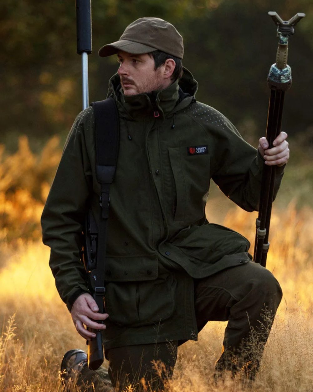 Bayleaf coloured Stoney Creek Mens Suppressor Jacket on forest background 