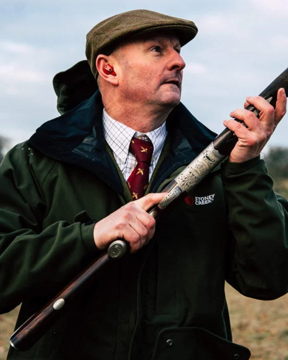 Bayleaf coloured Stoney Creek Mens Suppressor Jacket on forest background 