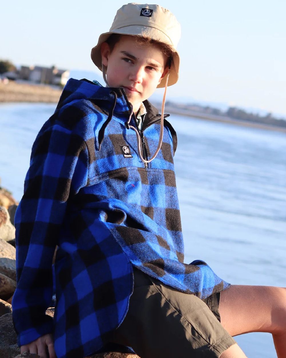 Blue Black Check Coloured Swanndri Kids Brixton Wool Bushshirt on sea background 