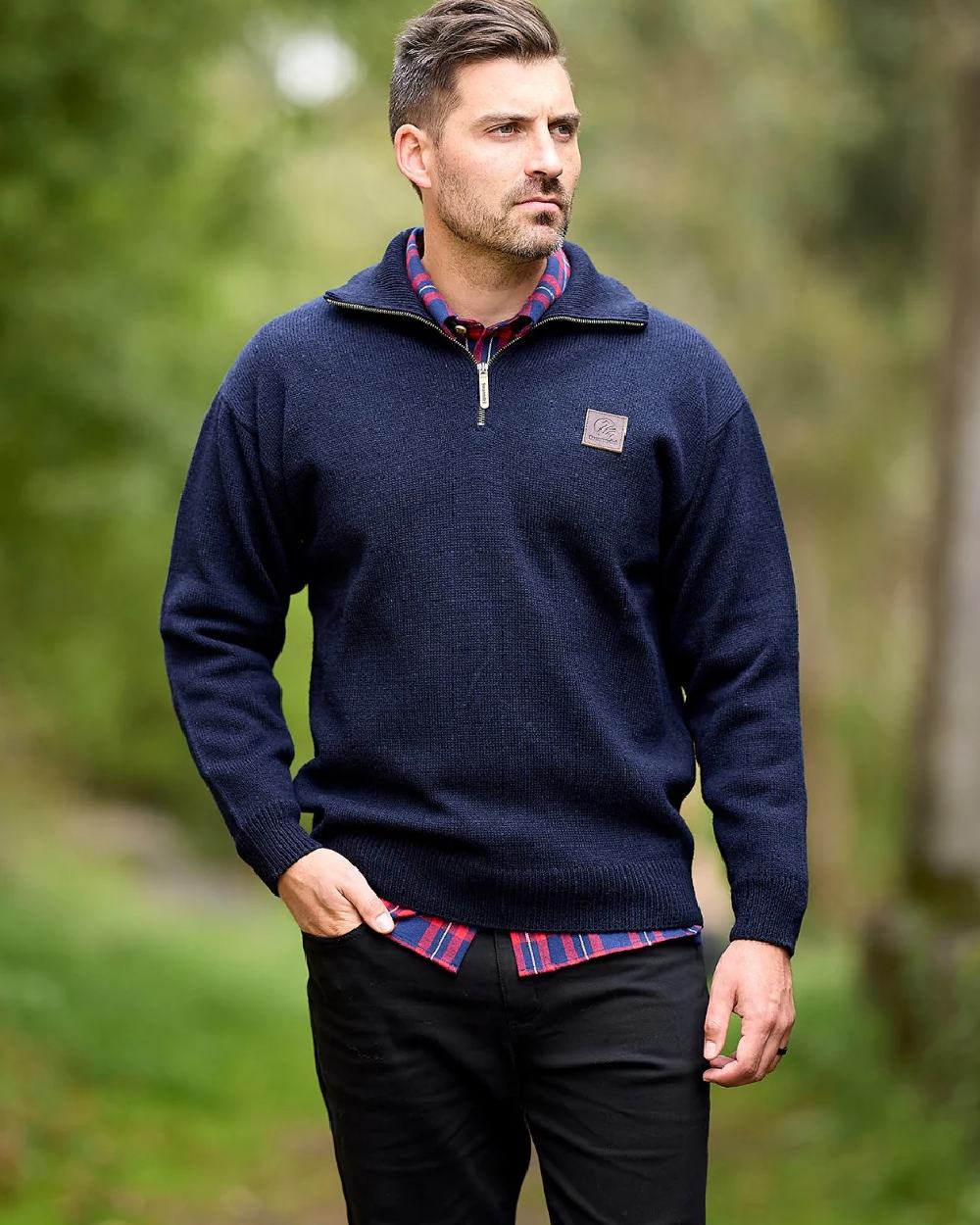 Navy Coloured Swanndri Mens Mariner Wool Zip Neck Sweater on blurry background 