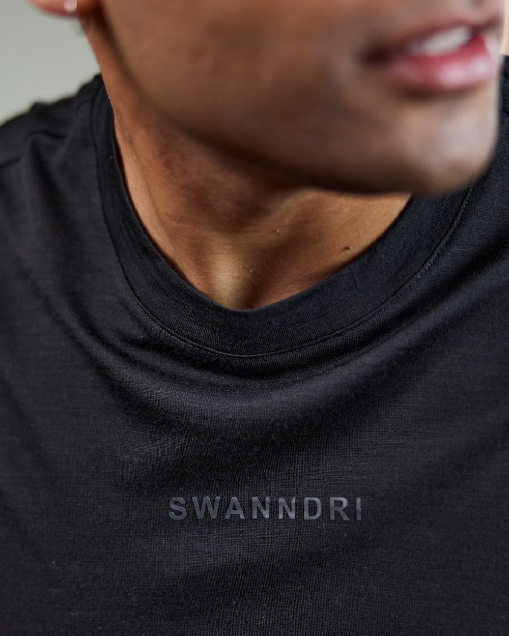 Black Coloured Swanndri Mens Merino Fusion T-Shirt on blurry background 