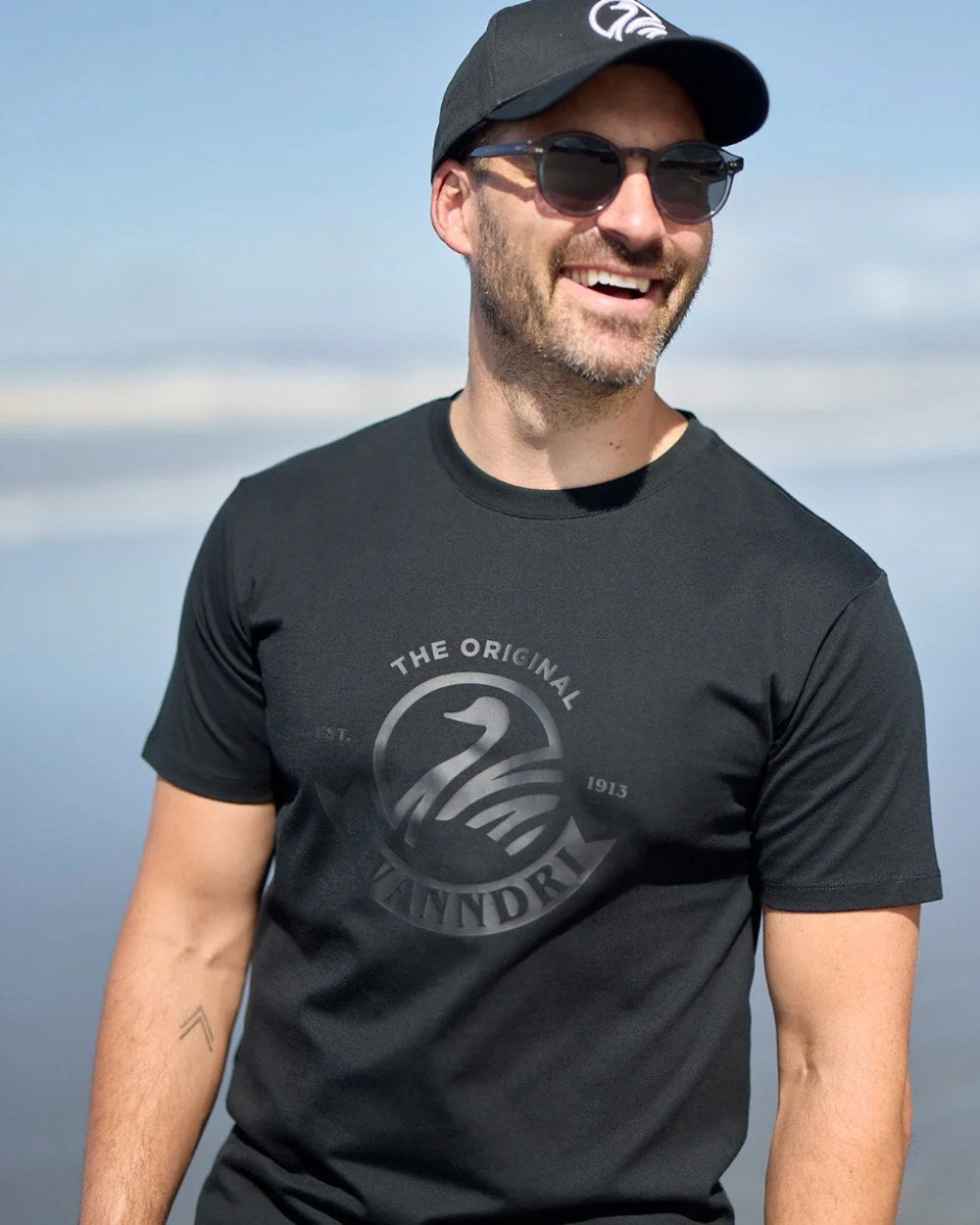 Black Coloured Swanndri Mens Original V2 T-Shirt on sky background 