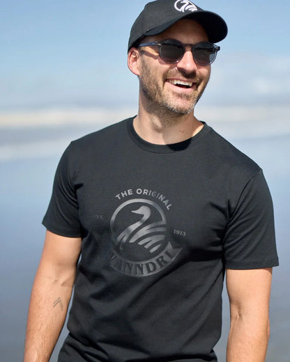 Black Coloured Swanndri Mens Original V2 T-Shirt on sky background 