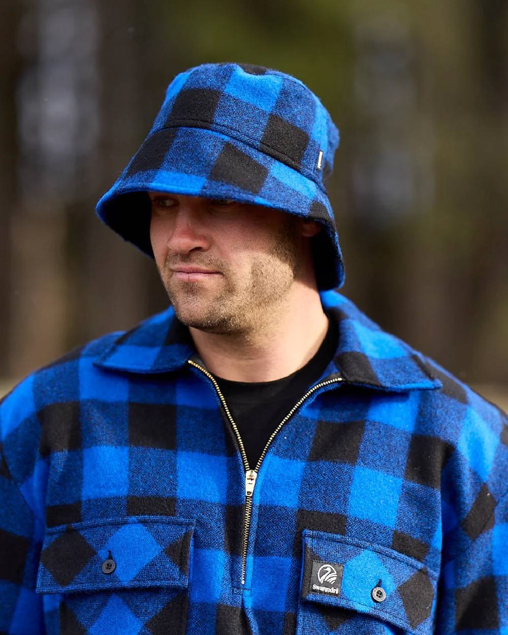 Blue Black Check Coloured Swanndri Mens Ranger Wool Zip Front Bushshirt on blurry background 