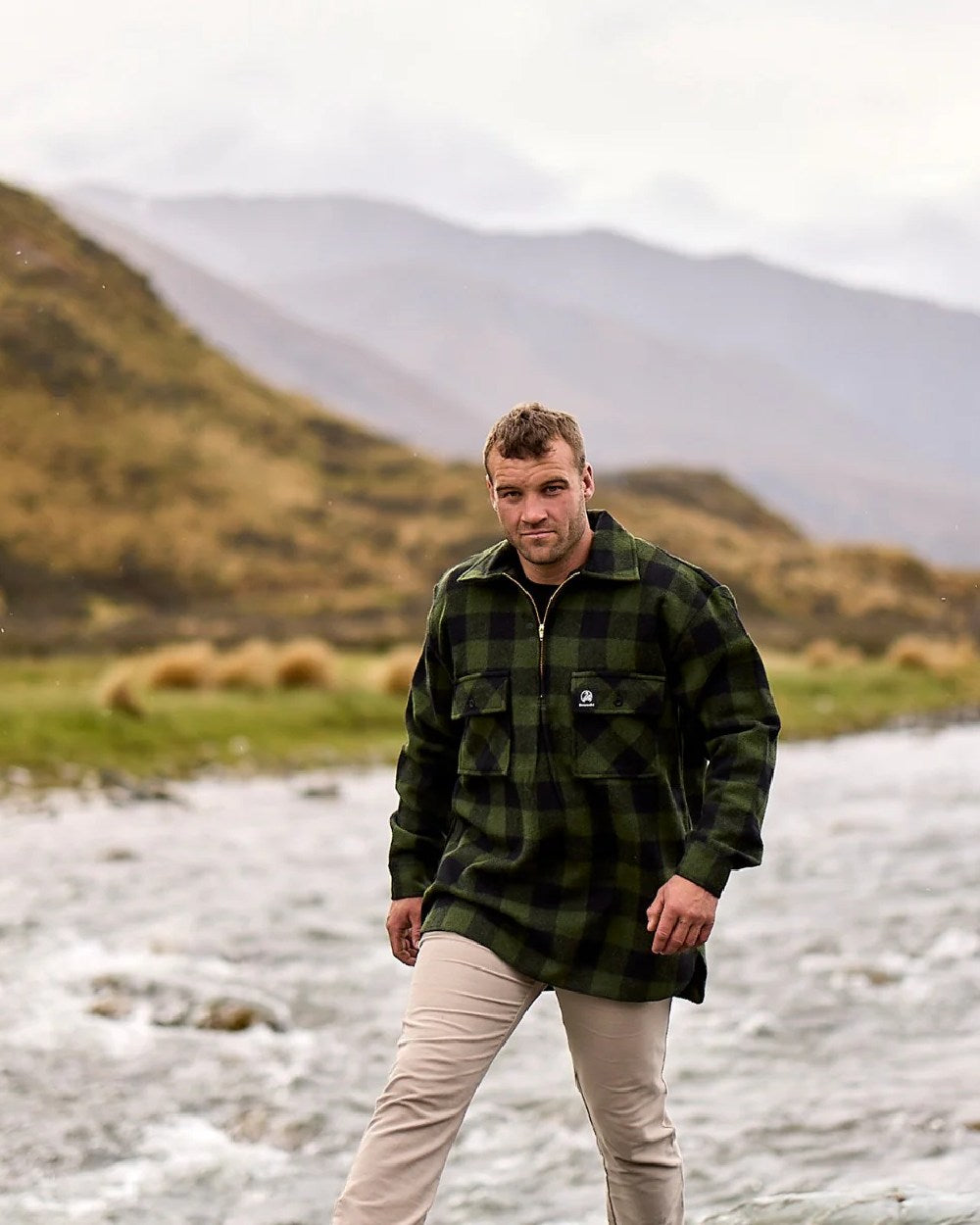 Olive Black Check Coloured Swanndri Mens Ranger Wool Zip Front Bushshirt on mountain background 