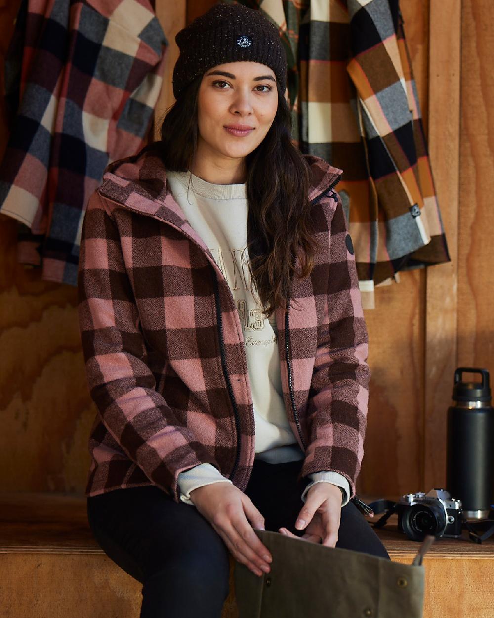 Rose Coffee Check Coloured Swanndri Womens Seattle V2 Wool Hooded Sweater on indoor background 