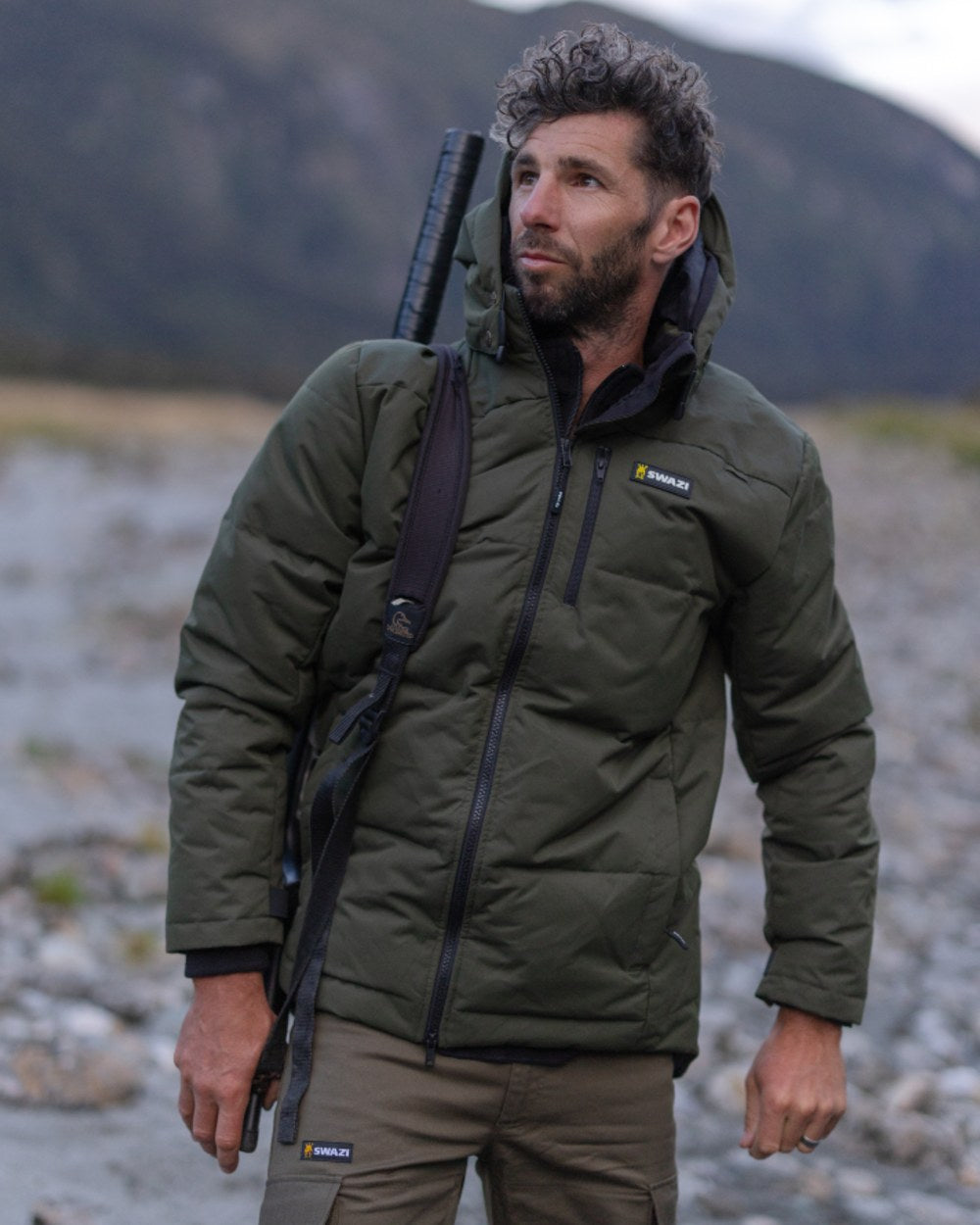 Olive coloured Swazi Mens Jack Frost Insulation Jacket on forest background 
