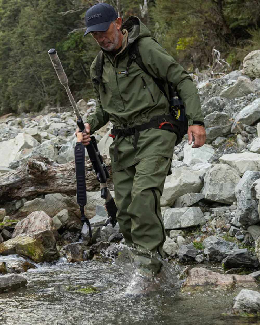 Olive coloured Swazi Mens Rifleman Ultralite Overpants on rock background 