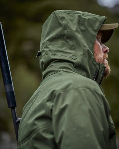 Olive coloured Swazi Mens Sentinel Ultralight Jacket on nature background 