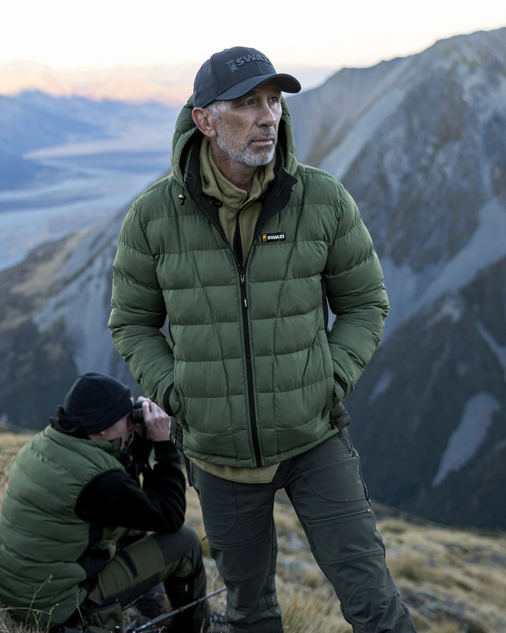 Olive coloured Swazi Puffadder Jacket on mountain background 