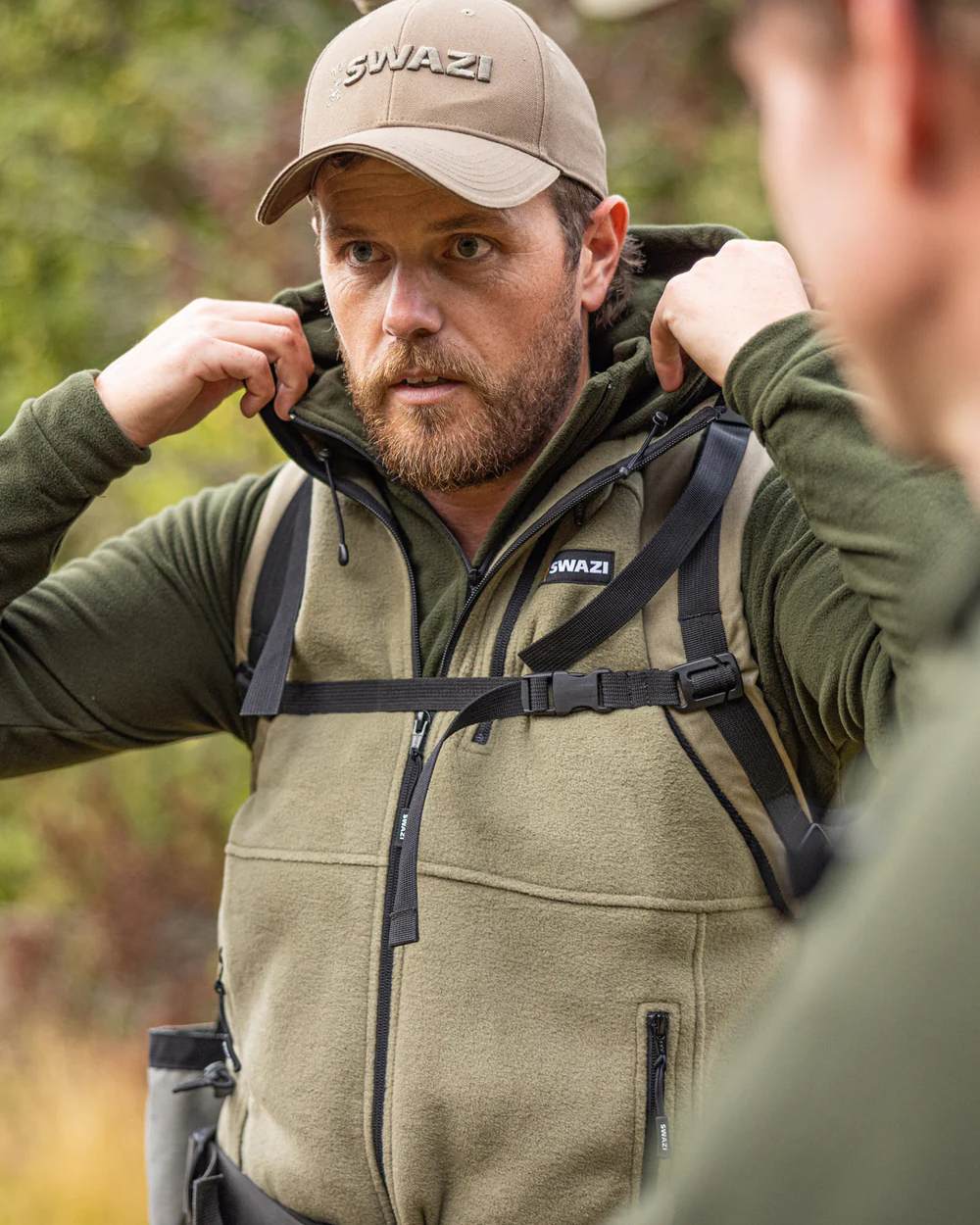 Tussock Coloured Swazi Sherpa Vest on blurry background 