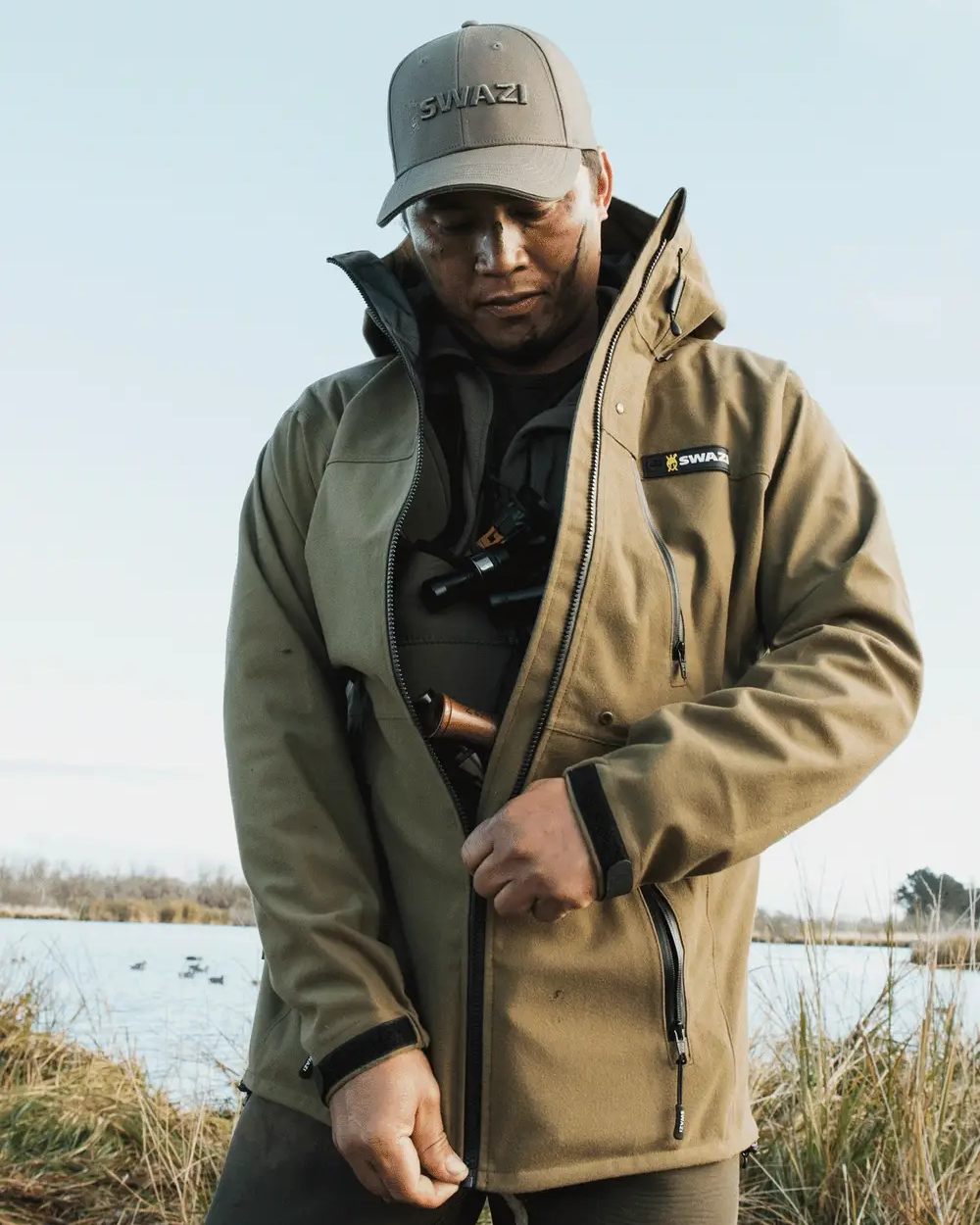 Tussock Green coloured Swazi The Ibex Jacket on sky background 